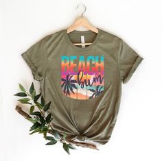 "Beach Bum Shirt, Beach Graphic Shirt, Beach Bum T-Shirt, Summer Vacation T-Shirt, Summer Beach Shirt, Beach Fun Tee, Funny Beach Shirts ☀️☀️☀️☀️☀️ Everything in our shop is hand crafted and made to order. If you want different color or size contact me! If you would like something custom made to fit your personal style please message me and I will do everything to get you that something special. ---How To Order--- ⭐️Please, check and review all photos ⭐️Choose your t-shirt size and color ⭐️Enter Fun Green T-shirt For The Beach, Green Letter Print T-shirt For Vacation, Screen Print T-shirt For Beach Vacation, Vacation Green Shirt With Graphic Print, Green Graphic Print Vacation Shirt, Vacation Green Graphic Print Shirt, Green Graphic Print Shirt For Vacation, Vacation Shirt With Graphic Print For Beach Party, Vacation Beach Party Shirt With Graphic Print