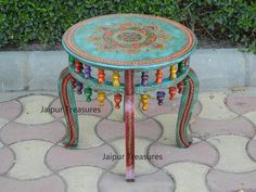 a small table with colorful decorations on it's sides and the words jalipur treasures written below