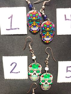 HANDMADE SUGAR SUGAR EARRINGS set 4 --choose from #1-9 and that exact one you will receive :) If you would like many please message us :) DETAIL IS AMAZING! NOT ONE IS THE SAME! COOLER IN PERSON! Set 4 Halloween Skull Jewelry With Skull Print, Halloween Skull Print Skull Earrings, Multicolor Skull Jewelry For Day Of The Dead, Day Of The Dead Multicolor Skull Jewelry, Handmade Bohemian Earrings For Halloween, Halloween Skull Jewelry With Ear Wire, Bohemian Halloween Earrings As Gift, Bohemian Earrings For Halloween Gift, Bohemian Halloween Gift Earrings