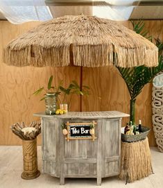 a tiki bar with straw umbrella and palm trees