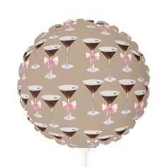 a ball with martini glasses and bows on it