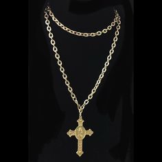 Our Matte Gold Cross of Saint Benedict (aka San Benito) is a sacramental holy medal that has been believed to repel evil for centuries. It hangs on a 34" etched cable chain with a shepherds hook that allows it to be worn an unlimited number of ways because the hook can be fastened on any of the cable links. You can wear it doubled and short of mid length as a lariat or as a long layering piece with your other Whispering Goddess necklaces. The cross itself is timeless and according to the Benedic Antique Brass Cross Pendant Necklace, Engraved Cross Necklace For Blessing, Antique Gold Jewelry For Blessing, Antique Gold Jewelry For Blessing Occasions, Engraved Cross Necklace For Commemoration, Antique Engraved Cross Pendant Necklace, Spiritual Engraved Cross Pendant Jewelry, Bronze Engraved Cross Necklace, Engraved Spiritual Cross Pendant Jewelry