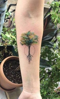 a tree tattoo on the arm