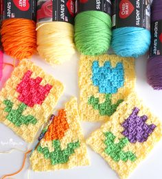 several crocheted squares with different colors of yarn and thread in them on a white surface