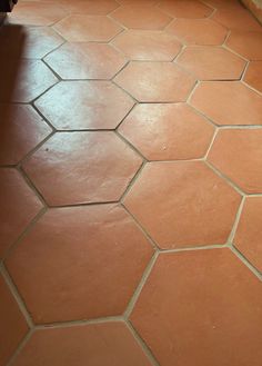 a bathroom floor with an orange tile pattern