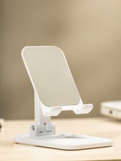 a white cell phone holder sitting on top of a desk