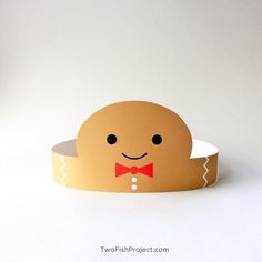 a paper ginger with a bow tie on it's head is sitting in front of a white background