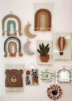 several wall hangings with various designs and colors on them, including a teddy bear