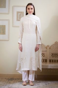 Ivory kurta with embroidered floral motifs on hem and sleeve hems. Comes with pant and sheer dupatta.
Component: 3
Embroidery
Neckine: Round
Sleeve Length: Bracelet
Fabric: Chanderi jacquard, Viscose
Color: White
Side slits on kurta - Aza Fashions Traditional Long Sleeve Kurta With Embroidered Cuffs, Elegant Traditional Wear With Embroidered Border In Off White, Elegant Off White Traditional Wear With Embroidered Border, Elegant Salwar Kameez With Embroidered Border For Spring, Designer Embroidered Cuff Kurta For Eid, Eid Fitted Kurta With Embroidered Cuffs, Festive Cotton Kurta With Embroidered Cuffs, Off White Traditional Wear For Spring Wedding, Designer Cream Kurta With Floral Embroidery