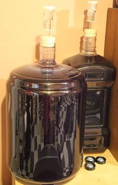 two black bottles sitting on top of a counter