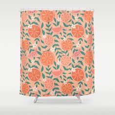 a shower curtain with oranges and leaves on it