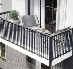 a balcony with a chair and potted plant on the top floor next to it