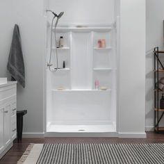 a bathroom with white walls and wooden floors