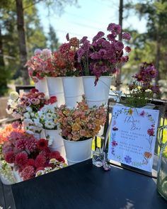 a table topped with lots of potted flowers