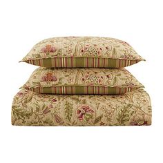 two pillows stacked on top of each other in front of a white background with red and green flowers