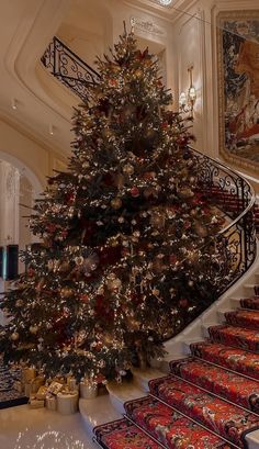 a decorated christmas tree sitting on top of a set of stairs