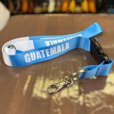 Show your pride with a Guatemala lanyard keychain. Featuring a durable blue strap, metal hook, and the word 'GUATEMALA' along with the national flag, this lanyard is perfect for keys, ID badges, and more. The high-quality materials ensure long-lasting use, while the eye-catching design makes it a standout accessory. Ideal for everyday use, travel, or as a gift for anyone who loves Guatemala. Spanish: Muestra tu orgullo con un llavero de cordón de Guatemala. Con una correa azul duradera, un gancho de metal y la palabra "GUATEMALA" junto con la bandera nacional, este cordón es perfecto para llaves, tarjetas de identificación y más. Los materiales de alta calidad garantizan un uso duradero, mientras que el llamativo diseño lo convierte en un accesorio destacado. Ideal para el uso diario, viaj Blue And White Flag, Guatemala Flag, Keychain Lanyard, White Flag, Lanyard Keychain, Flag Colors, National Flag, Id Badge, Guatemala