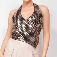 Elevate Your Evening With Our Surplice Halter Sequin Top, A Dazzling Piece That Merges Modern Nostalgia With Sophistication. Designed To Make A Memorable Impression, This Top Features A Unique Combination Of Elegance And Glamour Perfect For Any Soire. Key Features: - Fabric: 95% Polyester, 5% Spandex, Providing A Blend Of Durability, Stretch, And Comfort. - Fit: Regular Fit With A Flattering Waist-Length Cut. - Color Options: Black/Rose Gold. - Sizes: Available In S, M, And L. - Design: The Halt Glamorous Halter Neck Top For Party Season, Glamorous V-neck Tops For Date Night, Sequin Halter Neck Top For Night Out, Glamorous Halter Neck Tops For Night Out, Glamorous Halter Neck Top For Evening, Fitted Halter Neck Top For Party, Fitted Halter Neck Party Top, Sequin Halter Top For Night Out In Spring, Sequin Halter Top For Spring Night Out