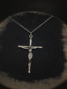 a silver cross on a black background