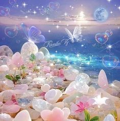 there are many bubbles floating in the water and some flowers on the rocks near the ocean