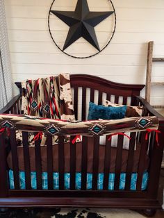 a baby crib in front of a wall with a star hanging on the wall