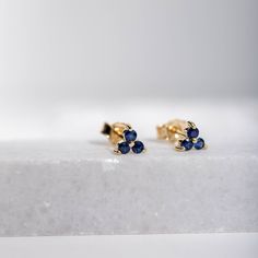 Trinity cluster blue sapphire stud earrings in 14K gold, featuring three stones, a perfect September birthstone gift for girl or girlfriend. ● Material: 14K solid gold - white gold ● Dimensions: 4mm x 4mm ● Gemstone: Sapphires 2mm ● Sapphires' Weight: 0.28ct HOW TO ORDER  ● Choose from the drop down menu the available options (Material) and leave us a note for any special requirements. PRODUCTION TIME - SHIPPING POLICIES ● Please keep in mind that each item is handcrafted, and we need 5 days at Yellow Gold Three-stone Earrings For Gift, Three Stone Yellow Gold Earrings For Gifts, Classic Three Stone Earrings As Gift, Classic Three Stone Earrings For Gift, Classic Three Stone Earrings Gift, Gold Three-stone Earrings For Gift, Sterling Silver Three-stone Earrings As A Gift, Birthstone Stacking Rings, Sapphire Stud Earrings