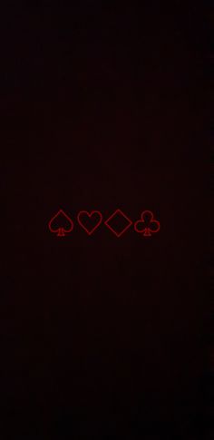 three hearts and four spades on a black background with red light in the middle