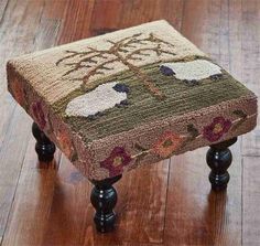 a small foot stool sitting on top of a hard wood floor