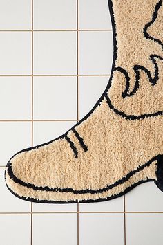 a bathroom rug with a boot on the floor