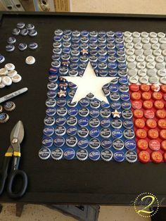 an american flag made out of beer bottle caps with scissors and pliers on the table