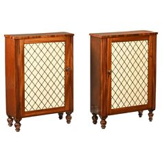 a pair of wooden cabinets with glass doors on the front and back sides, both side by side