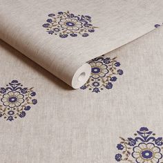 the fabric has blue flowers on it and is made from linen with an intricate design