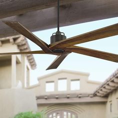 an outdoor ceiling fan in front of a house