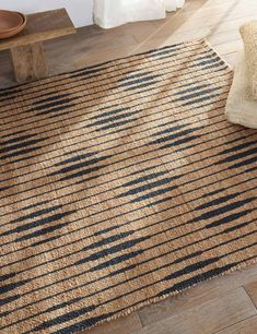 a brown and black area rug on a wooden floor