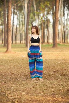 These cute hippie pants are colorful pants and handmade with rayon fabric which make them super comfy to wear. They have an elastic waist and elastic ankles. The two pockets are fitted with decorative strings. These trousers are are perfect for relaxing at home, working out, yoga running, beachwear and general casual wear. Also recommended for Thai massage, dance and festivals. Lannaclothesdesign products are uniquely designed and latest fashion trends. You can choose from many different colors Summer Harem Pants With Pockets, Casual Multicolor Wide-leg Harem Pants, Blue Bohemian Wide Leg Pants For Vacation, Beach Cotton Ankle-length Harem Pants, Casual Multicolor Harem Pants For Vacation, Beach Ankle-length Cotton Harem Pants, Bohemian Blue Pants For Vacation, Ankle-length Blue Harem Pants For Vacation, Bohemian Beach Cotton Pants