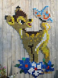 a wall made out of legos with the character woody from toy story