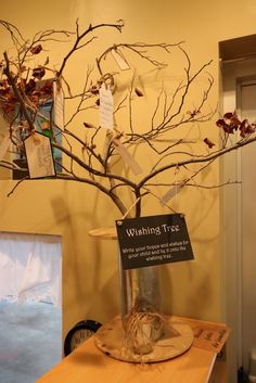 a tree that has been placed on top of a table with tags attached to it