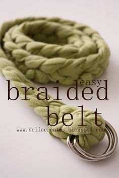 the braided belt is green and has a metal ring on it's end