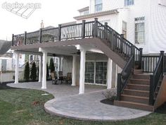 an outdoor patio with stairs leading up to the second floor