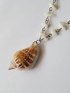 Mother of pearl chain necklace with a large conch shell pendant! This necklace is a little longer and perfect for a day at the beach. Ocean-inspired Pearl Necklace For Beach, Beach Shell Necklace Made Of Mother Of Pearl, Pearl Shell Necklace For Vacation, White Shell Necklace With Pearl Pendant, Ocean-inspired Shell-shaped Necklace With Pearl Pendant, White Shell With Pearl Pendant, Vacation Pearl Shell Necklace, Bohemian Pearl Chain Necklace For Beach, Ocean-inspired Shell Pendant Necklace