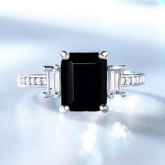 This Ring Features a 8X10 MM Emerald Cut Natural Black Onyx and Sterling Silver Finished with rhodium. Customization is available. It is made by hand, and it will take about 3 to 5 business days to finish the ring after your payment is completed. Product Description Main stone: Natural Black Onyx Metal type: 92.5 Sterling Silver finished with rhodium Accent stone: Zircon How To take care of Care This Ring - Keep the jewelry away from direct heat, water, perfumes, deodorants, and other strong che Black Gemstone Ring, Onyx Engagement Ring, Emerald Cut Diamond Ring, Emerald Cut Rings, Emerald Engagement Ring Cut, Right Hand Rings, Black Onyx Ring, Silver Wedding Rings, Onyx Ring