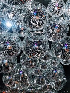 many shiny disco balls hanging from the ceiling