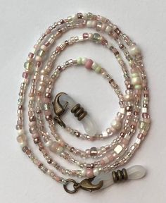 Warm taupe with blush and baby pinks, cream, and light green hues make up this beaded eyeglass chain.  Clear rubber and bronze eyeglass holders are attached at both ends.  Approximately 26 or 32 inches long in total length with the beaded portion being about 23 or 29 inches long.  My eyeglass chains are made using glass seed beads which range in size from about 1-2mm for the smallest beads up to 3-4mm for the larger beads. These beads are very small! If you would prefer black rubber connectors i Handmade Adjustable Pink Glasses Chains, Adjustable Pink Beaded Glasses Chain, Adjustable Pink Glass Glasses Chains, Handmade Pink Glass Glasses Chains, Eyeglass Holder Necklace, Beaded Eyeglass Chain, Eyeglass Chains, Cute Beads, Glasses Chains