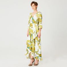 Featuring a refined print with a tropical macro pattern, this dress underlines your silhouette with grace. Enhanced with crossed ruffles in front and plunging back, seductive V neckline and embellished with tulip sleeves. Pair it with sandals for a casual bohemian style or with heels for a sophisticated look. An elegant item that will bring romance to your day or evening style. Main material 33% Rayon, 17% Nylon Machine wash, gentle cycle, 30 degrees max. Tropical Print V-neck Midi Dress For Garden Party, Beachwear Dress With Surplice Neckline For Vacation, Tropical Printed Dress For Brunch, Tropical Ruffle Dress For Garden Party, Spring V-neck Dress With Palm Tree Print, Summer V-neck Dress With Leaf Print, Floral Print Maxi Wrap Dress For Beach, Beach V-neck Printed Wrap Dress, Floral Print Maxi Wrap Dress For Vacation