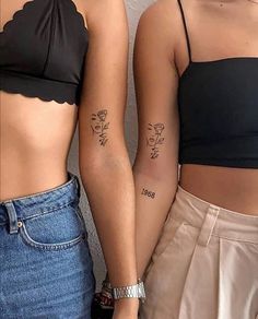 two women with matching tattoos standing next to each other