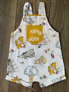 a winnie the pooh bib on a wooden floor