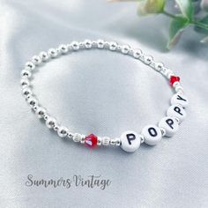 This .925 sterling silver July birthstone beaded stretch bracelet can be personalised with the name of your choice making it a truly one-of-a-kind, meaningful, and unique piece of jewellery  July is represented in the Swarovski birthstone chart as Ruby, a stunning vibrant red crystal that symbolizes charity, love, and contentment  The eclectic mix of beautiful beads are strung on high quality, strong, professional jewellers' elastic meaning there are no fiddly clasps to deal with, simply roll th Birthstone Chart, Birth Stones Chart, July Birthday, Ruby Crystal, Birthstone Bracelet, Birthstone Bracelets, Bracelet Sterling Silver, July Birthstone, Red Crystals