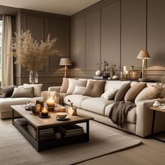 a living room filled with furniture and candles