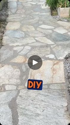 a stone path with a sign that says diy on it