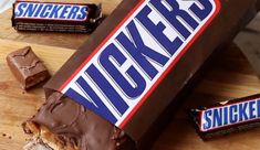 a bar of snickkers is sitting on a cutting board